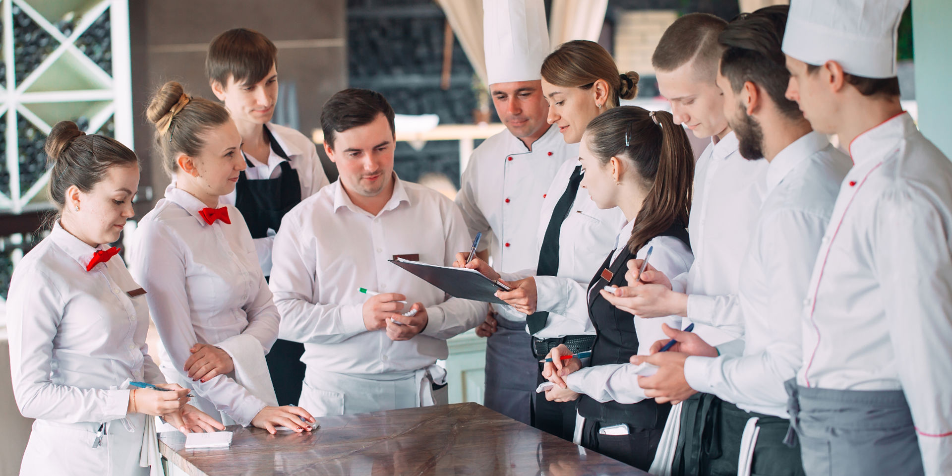 restaurant staff in uniform in meeting