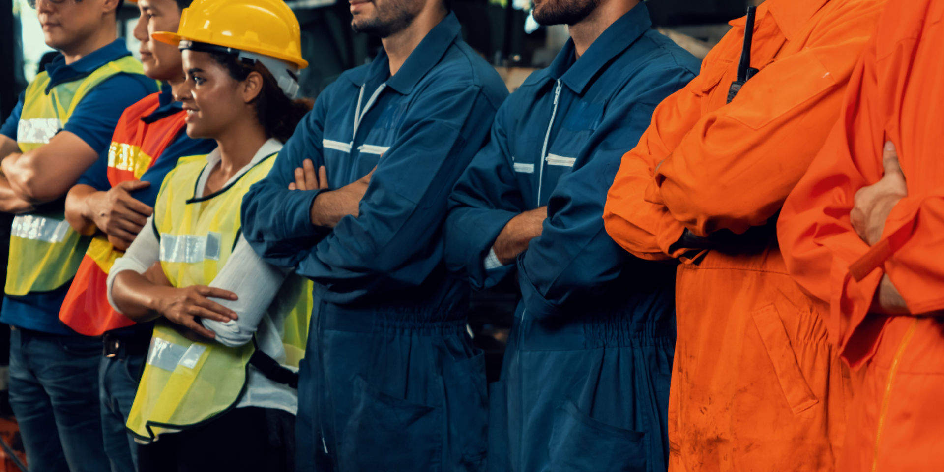 industrial workers in uniforms and vests